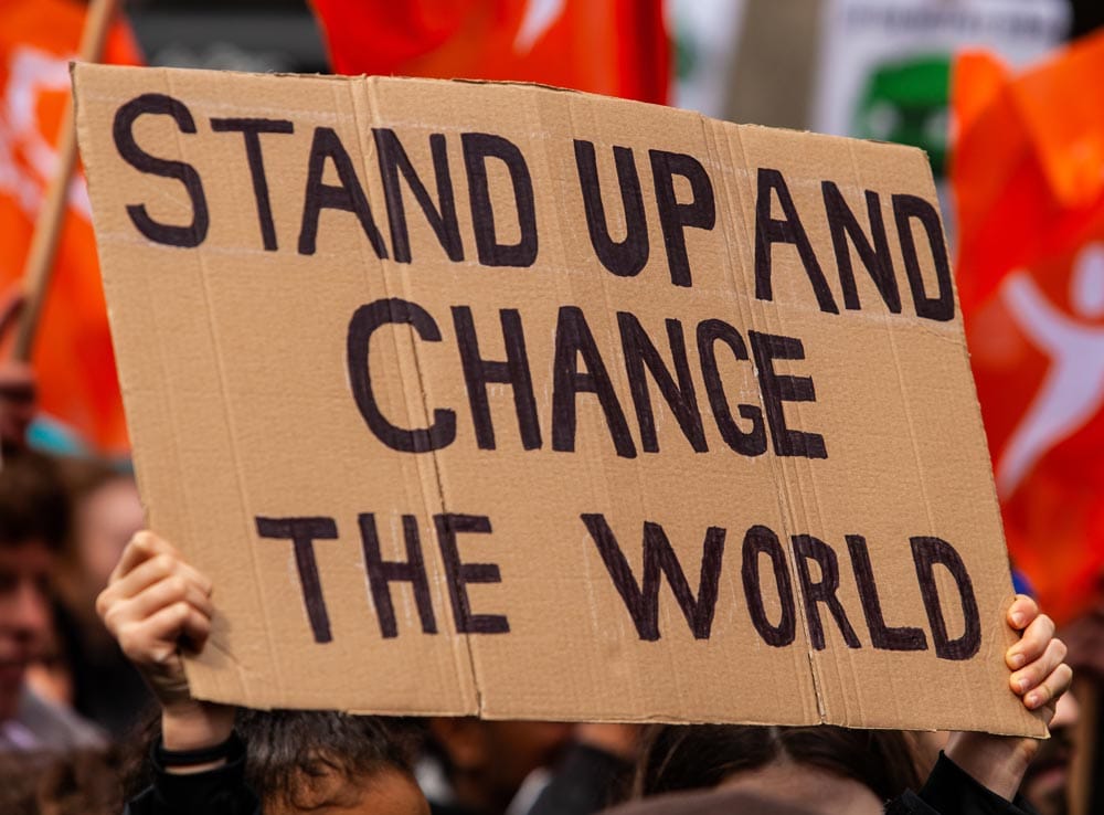 stand up and change the world sign